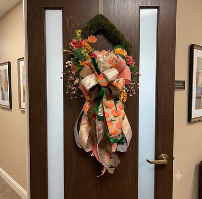 Peach Please moss diamond wreath hanging on a door